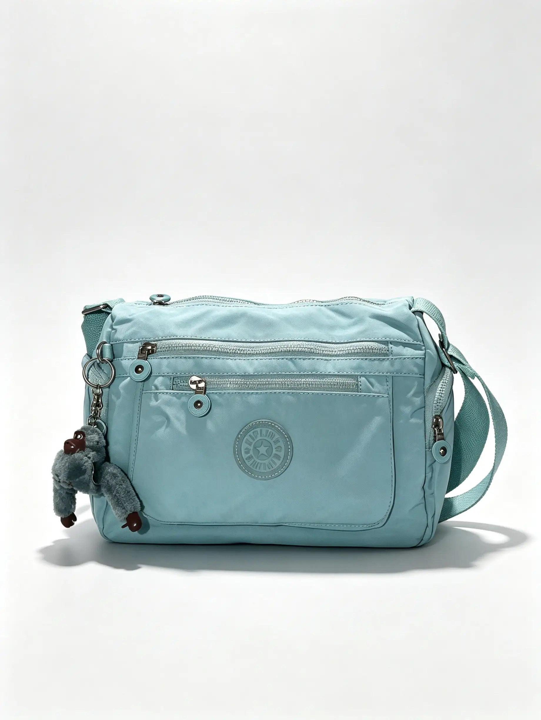 شنطة يد أزرق سماوي بجيب أمامي واسع وميدالية حيوان | Sky Blue Handbag with Large Front Pocket & Animal Charm
