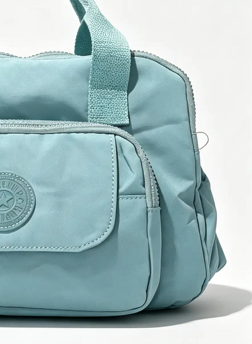Sky Blue Handbag with Large Front Pocket & Animal Charm | شنطة يد أزرق سماوي بجيب أمامي واسع وميدالية حيوان