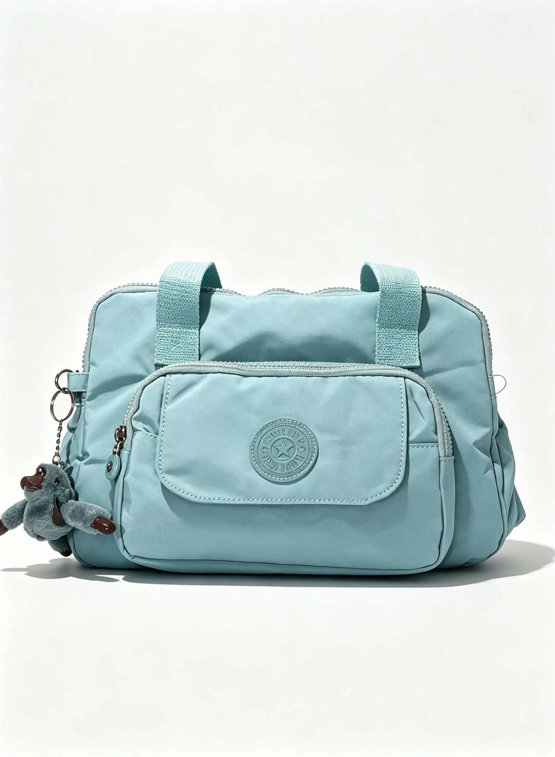 Sky Blue Handbag with Large Front Pocket & Animal Charm | شنطة يد أزرق سماوي بجيب أمامي واسع وميدالية حيوان