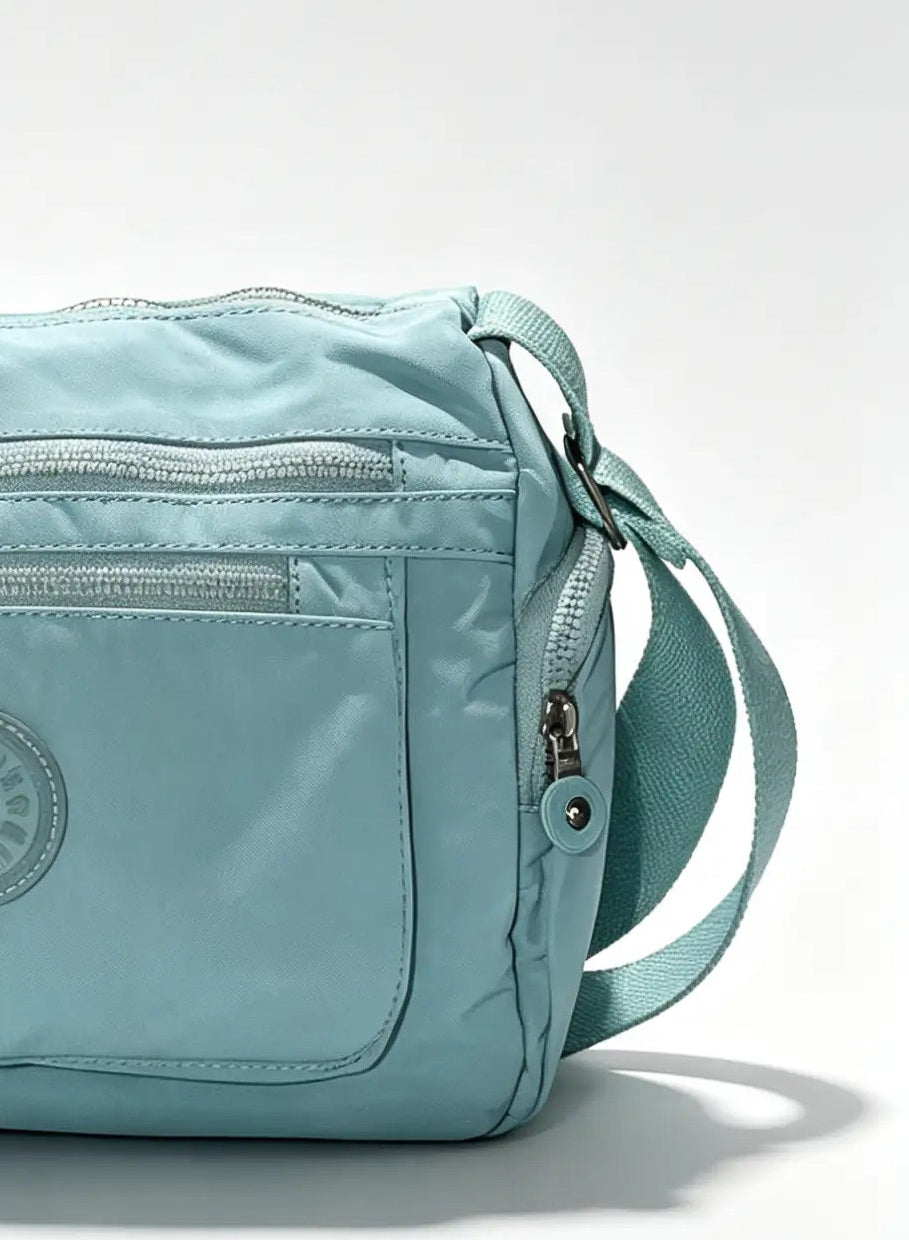 شنطة كروس أزرق سماوي متعددة الجيوب وميدالية حيوان | Sky Blue Crossbody Bag with Multiple Pockets & Animal Charm