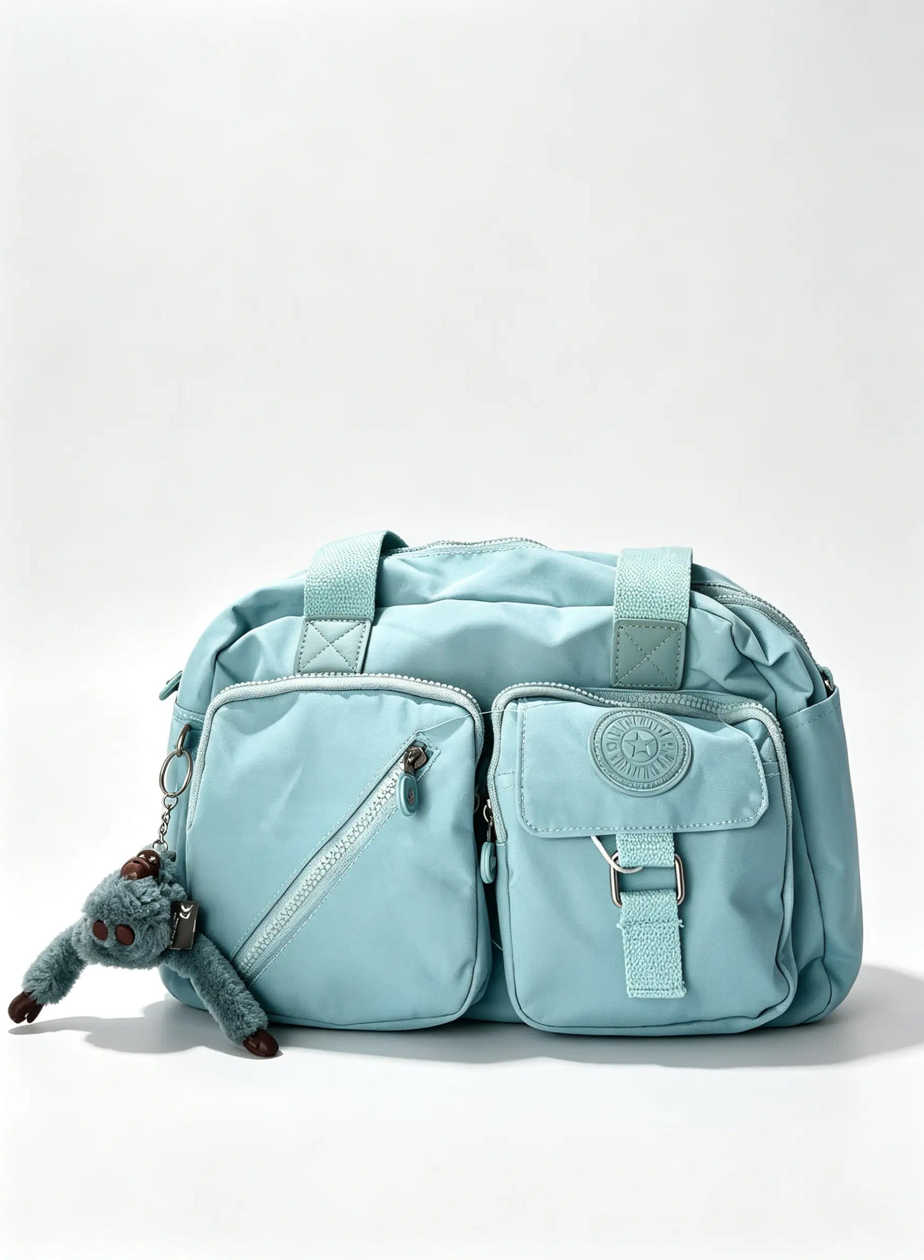 عشنطة يد أزرق سماوي كبيرة بجيبين أماميين وميدالية حيوان | Large Sky Blue Handbag with Double Front Pockets & Animal Charm