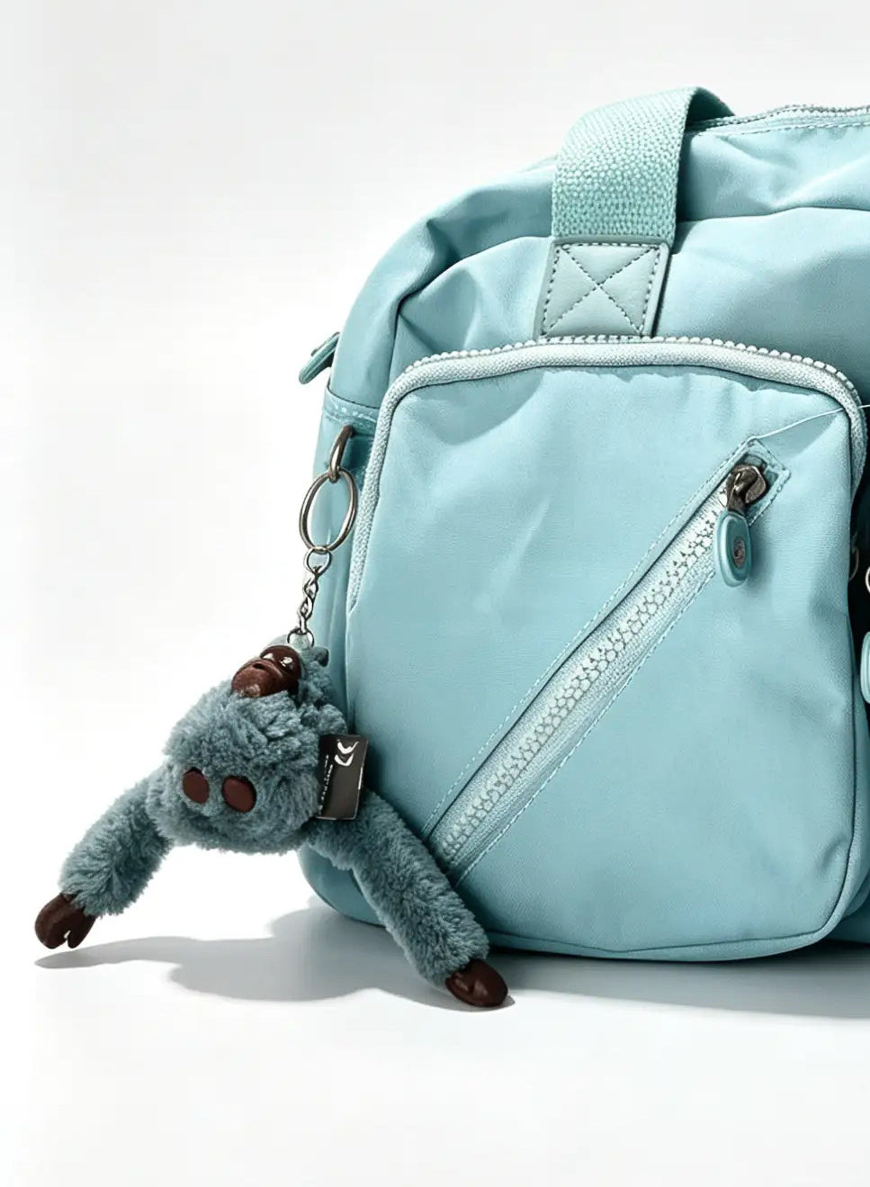 عشنطة يد أزرق سماوي كبيرة بجيبين أماميين وميدالية حيوان | Large Sky Blue Handbag with Double Front Pockets & Animal Charm